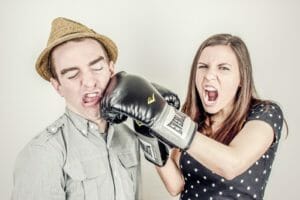 Girl hitting a guy with a boxing glove | Petpace